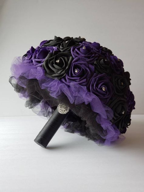 Custom made dark purple and black skull wedding bouquet. Each bouquet is hand made to order using real touch roses. Skulls and rhinestone accents are placed in the center of every rose making it a great addition to any Gothic/Halloween wedding. Handle is made up of satin ribbon and your choice of: Silver bling wrap No accessories on handle. Bouquets come in several sizes: 6 inch toss bouquet 8 inch bridal bouquet 10 inch bridal bouquet 12 inch bridal bouquet Matching Boutonnieres and corsages av Black And Purple Bridesmaid Dresses, Dark Purple And Black Wedding, Dark Purple Quince Dresses, Purple And Black Wedding Theme, Black And Purple Wedding Theme, Black And Purple Wedding Dress, Purple And Black Flowers, Black Wedding Bouquet, Purple And Black Wedding