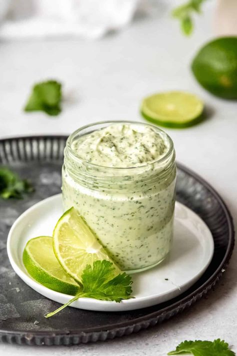 This Creamy Garlic Lime Cilantro Sauce recipe melds jalapeño, cilantro, garlic, & lime into a creamy condiment that's a must-have in your kitchen. Whipped up in just 5 minutes with only 5 ingredients, it's ideal for dressing up everything from grilled meats to your morning eggs. Think of it as the versatile 'little black dress' for your fridge—essential for any season and superbly adaptable. Whether used as a spicy spread, a zesty dip, or a bold dressing, it's sure to become your go-to sauce! Peruvian Green Sauce Recipe, Creamy Jalapeno Sauce, Pollo Tropical, Green Sauce Recipe, Cilantro Garlic Sauce, Summer Dinner Recipes, Creamy Jalapeno, Garlic Sauce Recipe, Jalapeno Sauce