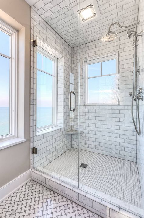 Shower tiling. Floor to ceiling shower tile. The shower features floor-to-ceiling Carrara marble tile. Shower with floor to ceiling tiles. Shower with floor to ceiling tiling. Shower with floor to ceiling subway tile. Mike Schaap Builders Shower Ceiling Tile, Luxury Tile Floor, Shower Windows Ideas, Shower Ceiling, Window In Shower, Beachfront Home, Luxury Tile, Ceiling Tile, Coastal Interiors