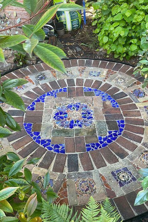 A mosaic patio made from bricks, pieces of broken ceramic, terracotta and marble. Mosaic Outdoor Floor, Recycled Garden Path, Crazy Paving Stepping Stones, Old Pavers Reusing, Mosaic Footpath, How To Make A Mosaic Garden Path, Mosaic Paving, Patio Mosaic, Mosaic Garden Ideas