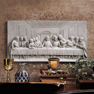 Honouring one of the most famous images of all time, this nearly-two-foot wide replica wall frieze draws upon Leonardo da Vinci's famed work and then brings it into a new realm in dimensional bas-relief. This impressive museum replica is cast in quality designer resin and finished with the patina of an aged stone. This timeless classic will fill a privileged place in-home or gallery. | Design Toscano The Last Supper Frieze Wall Decor White 12.0 x 23.0 x 2.5 in | Home Decor | TXG2594 | Wayfair Ca Last Supper Wall Decor Dining Rooms, Famous Images, Last Supper Painting, Last Supper Art, The Last Supper Painting, Gray Curtains, Room Focal Point, Catholic Decor, Sculpture Design