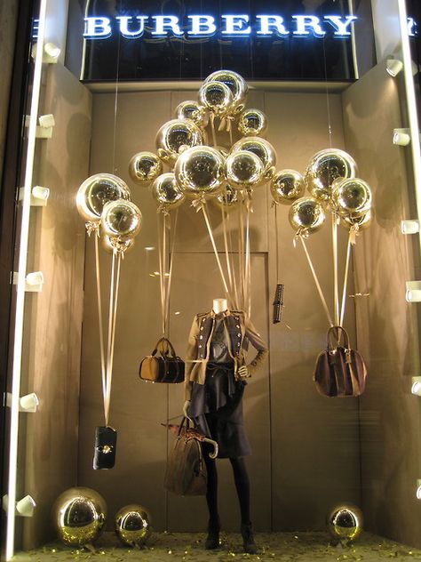 type:   fixture used: platform props used: maniquin lighting: night(maybe)  signs: burberry color:  bright, gold line: maniquin  shape: circle balance: formal emphasis:spotlight Burberry Store, Fashion Window Display, Window Display Retail, Decoration Vitrine, Visual Merchandising Displays, Store Window Displays, Christmas Window Display, Window Display Design, Retail Windows