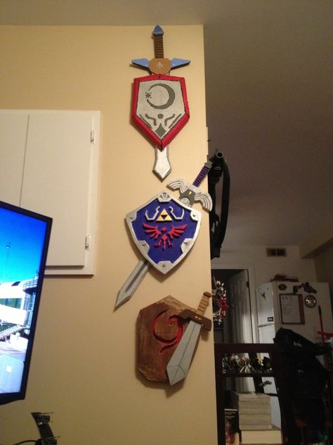 Three swords and shields of Ocarina of Time Zelda Diy, Zelda Party, Nerd Decor, Nerd Cave, Product Placement, Geek Decor, Link Zelda, Zelda Art, Ocarina Of Time