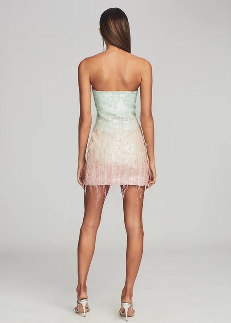 Let loose in our Anastasia Dress — a playful mini that will make any moment memorable. The shimmering dress features pastel sequins and airy feather embellishments throughout, creating a beautiful ombré effect. The strapless silhouette is designed with supportive boning through the bodice to contour the curves of the body and is finished with an invisible zip closure. Shown here in Feather. HANDMADE Self: 95% Polyester, 5% Lycra, Trim: 100% Ostrich Feather Made in India Sequin Feather Dress, Alphabet Earrings, Shimmering Dress, Halloween Crop Top, Anastasia Dress, Halloween Skirt, Feather Dress, Ombre Effect, Invisible Zip