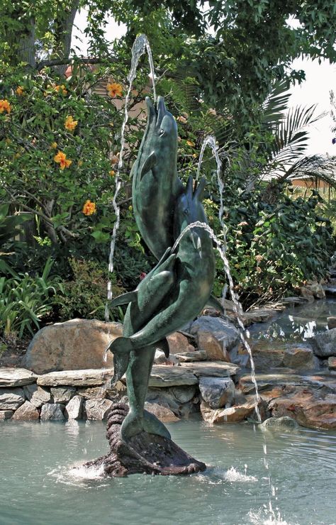 Entwined Dolphins Sculpture by Brass Baron This stunning sculpture displays two dolphins entwined in a continuous expression of their love and compassion for one another. Bring this element of supreme joy into your home's outdoor decor by accenting your outdoor water fountain, pond, and garden with this one-of-a-kind handcrafted aquatic sculpture. Featuring jet streams of water, this masterpiece is truly a classic, designed by the prestigious Brass Baron artisan company. - Measures 80 inches tal Dolphin Statue, Beautiful Gates, Dolphin Decor, Modern Fountain, Dolphin Gifts, Decorative Pebbles, Fountain Design, Water Fountains Outdoor, Outdoor Fountain