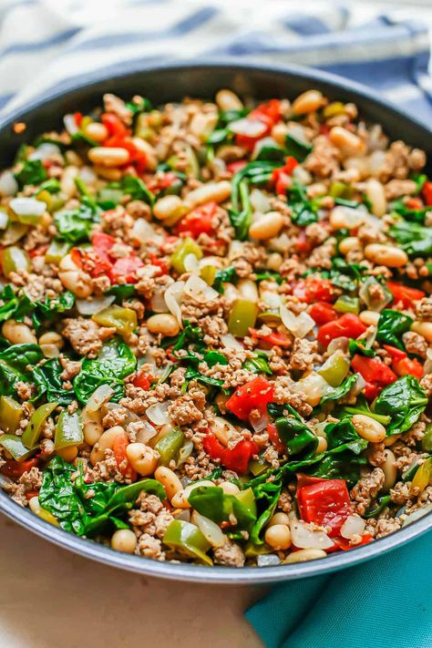 Italian ground turkey skillet with white beans, diced tomatoes and spinach is an easy, flavorful all-in-one-pan dinner that’s ready in just 25 minutes! Kale And Ground Turkey Recipes, Spinach Recipes Dinner Healthy, Ground Turkey Chickpea Recipe, Ground Turkey Potato Skillet, Low Cal Ground Turkey Recipes, Ground Turkey And Mushroom Recipes, Ground Turkey Mediterranean Recipes, Easy Healthy Ground Turkey Recipes, University Recipes