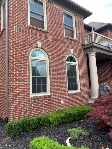 Large brick home with beautiful column pillars and landscaping. Windows show grids throughout window glass pane. Windows are beige while landscaping is bright dark green and deep red Japanese maple tree. Add Window Grids, Window Grids, Walk In Bathtub, Gutter Guard, Window Replacement, Grid Style, Picture Windows, Yes Or No, Vinyl Siding