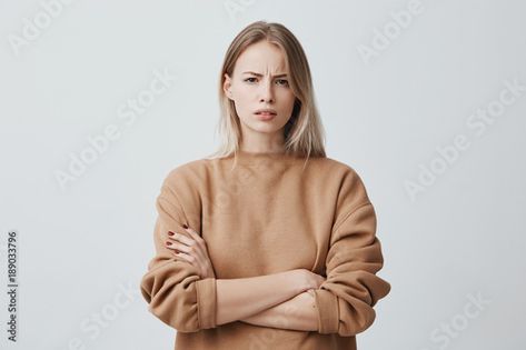 Stock Image: Waist-up portrait of beautiful girl with blonde straight hair frowning her face in displeasure, wearing loose long-sleeved sweater, keeping arms folded. Attractive young woman in closed posture. Frowning Face, Nail Whitening, How To Pose For Pictures, Straight Blonde Hair, Facial Exercises, Sleeved Sweater, Anti Aging Facial, Nail Fungus, Hydrogen Peroxide