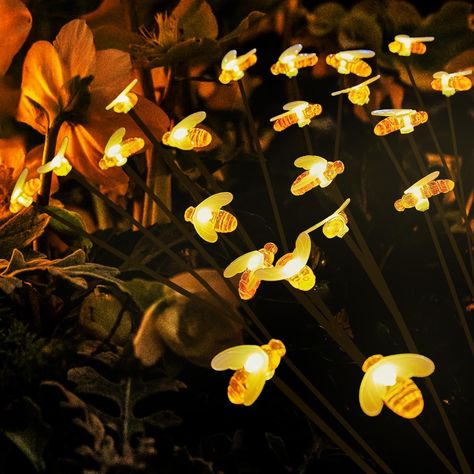 PRICES MAY VARY. Romantic Ambiance: Create a magical and romantic ambiance in your garden or yard with our 4-pack of 32 LED Solar Bee Lights. The flexible wires supporting each bulb sway with the wind, illuminating your space with a warm yellow glow, resembling fireflies flying by. Energy-Efficient: Our solar swing lights feature a built-in light sensor that automatically charges for 6 hours in sunlight during the day. The lights turn on automatically at night, offering 8-10 hours of continuous Bee Lights, Solar Christmas Lights Outdoor, Christmas Lights Outdoor, Fireflies In A Jar, Solar Christmas Lights, Glowing Flowers, Romantic Ambiance, Solar Garden Lights, Firefly Lights