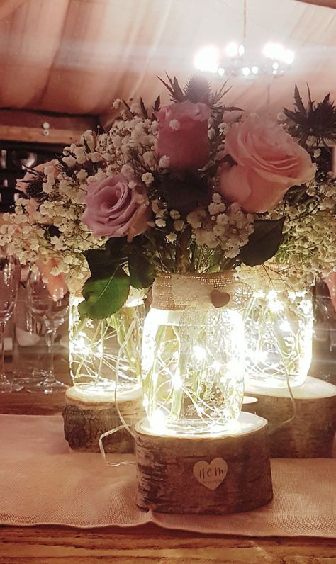 Vase With Lights And Flowers, Frosted Glass Centerpieces Wedding, Birthday Table Centrepieces, Fairy Light Floral Centerpieces, Mason Jar Roses Centerpieces, Fairy Lights In Vase With Flowers, Mason Jar With Lights Centerpiece, Lights In Jars Centerpieces, Wedding Decor Mason Jars