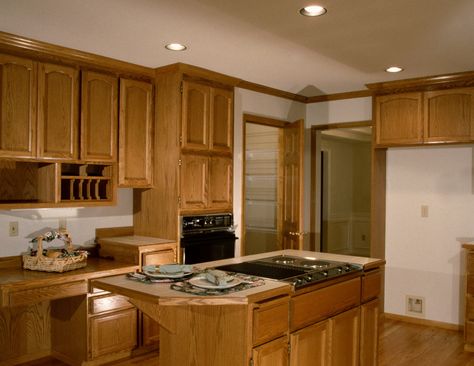 How to Darken Cabinets Without Removing Polyurethane. Warm, inviting shades of walnut, mahogany and cherry have replaced the dark brown, composite wood cabinets of the 1970s. Staining your kitchen cabinets a darker shade can give your kitchen an entirely different look and feeling and is not as difficult as you think. Plan to spend at least a... Stained Wood Kitchen Cabinets, Restaining Kitchen Cabinets, Glazed Kitchen Cabinets, Stained Kitchen Cabinets, Painting Oak Cabinets, Clean Kitchen Cabinets, Countertop Colours, Refinish Kitchen Cabinets, Maple Cabinets