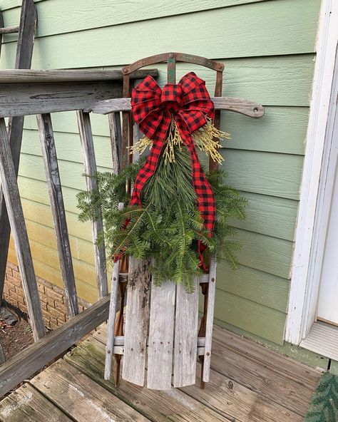 Outdoor Christmas Decor : red buffalo plaid bow & real evergreen boughs on a vintage wood sled for your porch or entry Front Porch Sled Decor, Sled Porch Decor, Decorating A Sled For Christmas Front Porches, Porch Sled Christmas, Antique Sled Decor Ideas, Old Sled Christmas Decor, Vintage Sled Christmas Decor Porch, Wood Sled Diy Christmas Signs, Christmas Sled Decoration