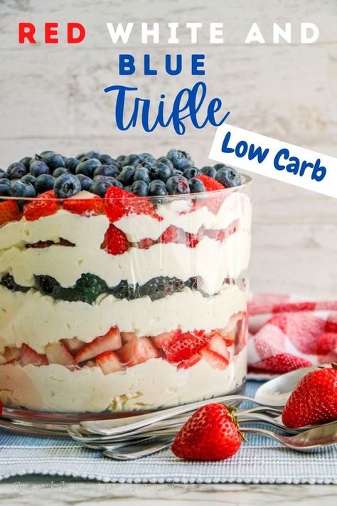 red white and blue trifle in a bowl with a few spoons and strawberries laying next to the bowl Berry Truffle Dessert Easy, Red White And Blue Triffle Desserts, Patriotic Trifle Dessert, Berry Truffle Dessert, Healthy Patriotic Desserts, Low Carb 4th Of July Food, Low Sugar Summer Desserts, Keto Trifle Desserts, Keto 4th Of July Desserts