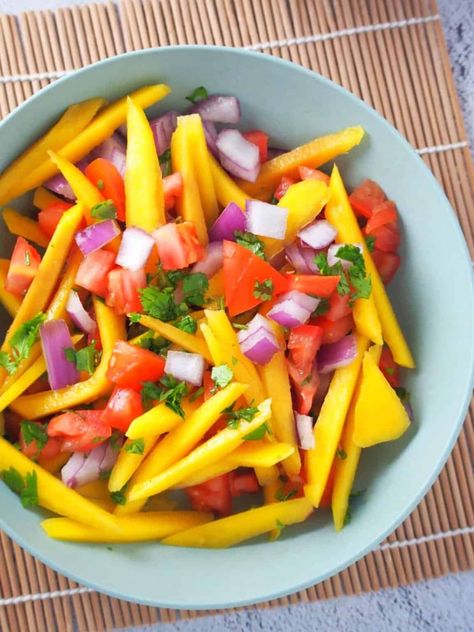 Filipino Mango and Tomato Salad is a light and refreshing side dish that pairs well with grilled meat or seafood. A delicious medley of juicy mangoes, plump tomatoes, onions, and cilantro tossed in an Asian-style vinaigrette dressing; it's like a party in your mouth! Filipino Mango, Kawaling Pinoy, Green Mango Salad, Vegetable Salad Recipes, Vinaigrette Salad, Weekly Meals, Tomato Sauce Recipe, Mango Salad, Salad Recipes For Dinner