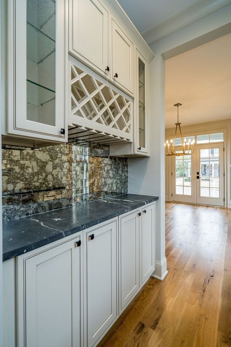 This wet bar feels very classic. We love the off-white cabinets with the two different tiles. No need to worry about spilling on this durable countertop. White Wet Bar, Off White Cabinets, Durable Countertops, Bar For Home, Home Entertaining, Dry Bars, Beverage Refrigerator, Dry Bar, Wet Bars