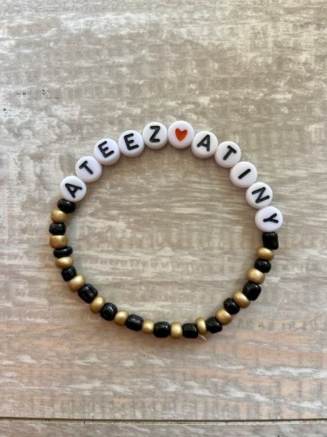 ATEEZ ATINY beaded Kpop bracelet, black & gold beads. Comes packaged with care, includes photocard (not official) and stickers. Kpop Clay Bead Bracelet, Ateez Bracelet Ideas, Ateez Bracelet, Kpop Bracelet, Aesthetic Supplies, Kawaii Bracelet, Ateez Concert, Clay Bracelets, Easy Perler Beads Ideas