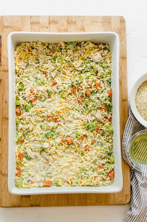 This chicken and rice casserole is healthier than most--filled with veggies, brown rice, and chicken--but still creamy, cheesy, and comforting! #chicken #rice #casserole #healthy #dinner #freezermeal Chicken Rice Casserole Healthy, Veggie Rice Casserole, Cheesy Chicken And Rice Casserole, Cheesy Chicken And Rice, Casserole Healthy, Chicken And Rice Casserole, Leftover Rotisserie, Chicken Rice Casserole, Gluten Free Bread Crumbs