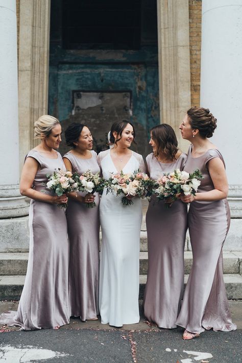 Bridal Party In Dusky Pink Bridesmaid Dresses With Bouquets | By Miss Gen | City Wedding | London Wedding | The Asylum Chapel | Candles At Wedding | Wedding Flowers | Bouquets | Lace Wedding Dress | Pink Wedding Flowers | Wedding Veil | Wedding Table Decor Pink Satin Bridesmaid Dresses, Dusky Pink Bridesmaid Dresses, Dusky Pink Bridesmaids, Charlie Brear Wedding Dress, Asylum Chapel, Blue Bridesmaid Dresses Short, Wedding London, Winter Bridesmaids, Indian Bridesmaid Dresses