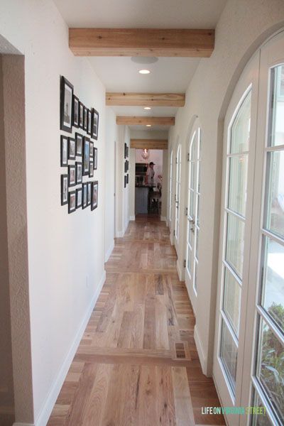 Gorgeous hallway with wood floors, french doors and exposed wood beams. Exposed Wood Beams, Wood Floor Pattern, Hallway Ceiling, Hotel Design Architecture, Wooden Beams Ceiling, Life On Virginia Street, Faux Beams, Faux Wood Beams, Wood Beam