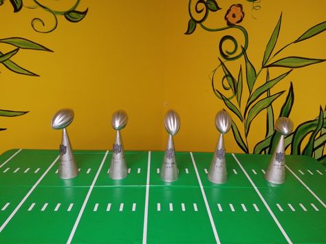 DIY Lombardi Trophies    Silver painted cardboard cones And football Painted Cardboard, Lombardi Trophy, Silver Paint, Sports Theme, Measuring Spoons, Football, Birthday, Silver, American Football