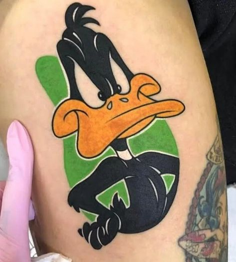 From Looney Tunes to Skin Art: Exploring Daffy Duck Tattoo Ideas - NSF - Magazine Daffy Duck Tattoo, Duck Tattoo Ideas, Duffy Duck, Cartoon Tattoo Ideas, Dynamic Tattoo, Animated Shows, Whimsical Tattoos, Duck Tattoos, Cartoon Tattoo