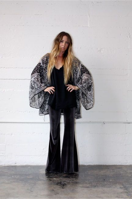 These bell bottoms derived from this era and are coming back into style. Black Velvet Kimono Outfit, Velvet Bell Bottoms Outfit Winter, Black And White Boho Outfits, Black Velvet Bell Bottoms Outfit, Velvet Bell Bottoms Outfit, Black Bell Bottoms Outfit, Black Shoes Outfit, Bell Bottom Pants Outfit, Look Kimono