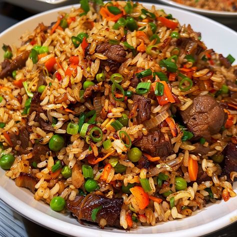 🍚 Indulge in the rich flavors of Oxtail Fried Rice! 🍖✨ #OxtailFriedRice #FlavorfulEats Oxtail Fried Rice Ingredients: Oxtail, cooked and shredded (1 lb) Cooked rice (4 cups) Garlic, minced (3 cloves) Onion, chopped (1) Carrots, diced (1 cup) Peas (1 cup) Soy sauce (3 tbsp) Oyster sauce (2 tbsp) Sesame oil (1 tbsp) Green onions, chopped (1/2 cup) Oil (for frying) Instructions: Heat oil in a large pan or wok over medium heat. Sauté garlic and onion until fragrant. Add carrots and peas, cook... Oxtail Fried Rice, Fried Oxtails, Fried Rice Ingredients, Best Fried Rice Recipe, Fried Recipes, Soul Food Dinner, Cooked Rice, Rice Ingredients, Tasty Recipes Videos