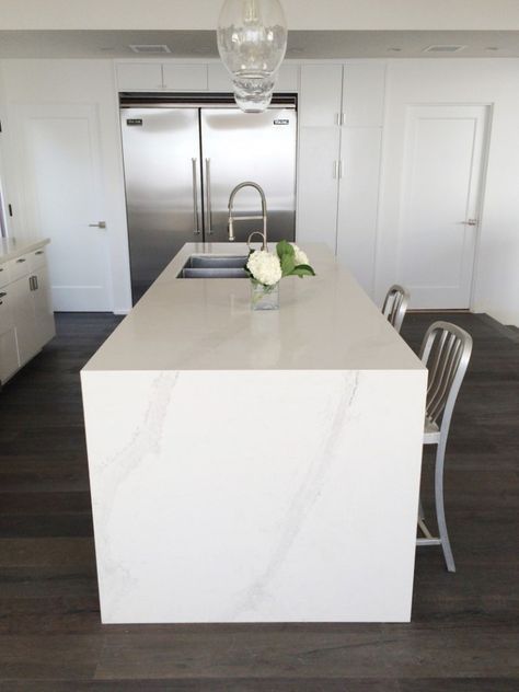 Caesarstone Calacatta Nuvo kitchen counters in a Malibu home. White quartz counters highlighted in a chef's kitchen. Caesarstone Calacatta Nuvo Kitchen, Caesarstone Calacatta Nuvo, Caesarstone Kitchen, Waterfall Countertop, Calacatta Nuvo, Replacing Kitchen Countertops, Kitchen Remodel Countertops, Kitchen Countertop Materials, Quartz Kitchen Countertops