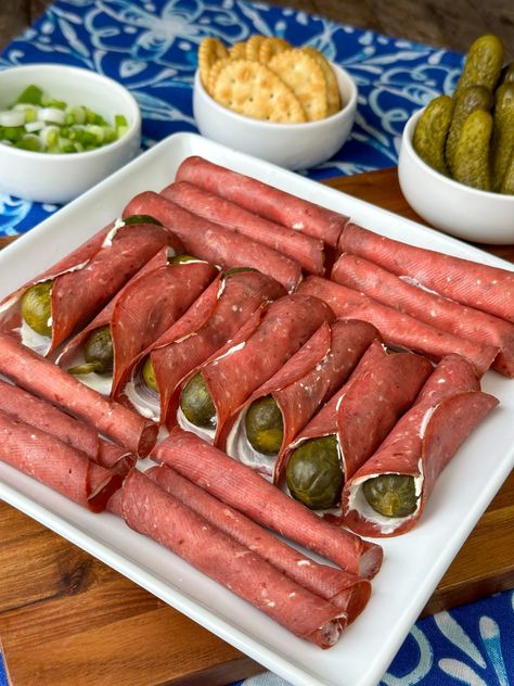 A row of dill pickles wrapped in a cream cheese and beef roll-up surrounded by perpendicular rows of plain dried beef and cream cheese roll-ups on a square white plate with crackers and pickles behind on a blue and white napkin. Roast Beef Cream Cheese Roll Ups, Turkey Cream Cheese Roll Ups, Dried Beef Roll Ups, Pickle Roll Ups, Beef Roll Ups, Church Recipes, Cream Cheese Roll Up, Dried Beef, Cheese Roll