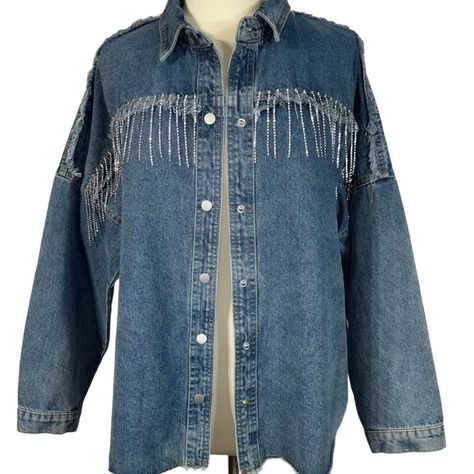 Vocal Cowgirl Rhinestone Bling Fringe Denim Snap Front Western Shirt Jacket / Shacket. Elevate Your Wardrobe With The Vocal Jacket, A Fusion Of Comfort And Style. This Stylish Piece Designed For Women, Features A Unique Rhinestone Fringe That Adds A Touch Of Sparkle To Your Everyday Look. Crafted From A Blend Of Cotton, Rayon, And Polyester, It Offers Durability Without Compromising On Softness. The Solid Blue Color Is Versatile, Making It Perfect For Both Casual Outings And Cocktail Parties. Its Snap Closure Ensures A Secure Fit, While The Long Sleeves And Collar Neckline Contribute To Its Classic Silhouette. Experience The Perfect Combination Of Fashion And Function With This Must-Have Sha Cowgirl Rhinestone, Rodeo Chic, Black And White Suit, Embellished Denim Jacket, Rhinestone Fringe, Studded Jacket, Embellished Denim, Burberry Jacket, Cocktail Parties