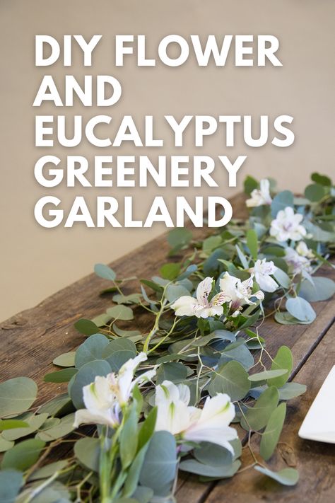 Text that reads "DIY Flower and Eucalyptus Greenery Garland" with a flower and eucalyptus garland laid on a wooden table underneath. Eucalyptus Garland With Flowers, Eucalyptus And Flower Garland, Wood Eucalyptus Centerpiece, Eucalyptus Wedding Centerpiece Floral Arrangements Table Garland, Eucalyptus Wedding Garland Long Tables, Silver Dollar Eucalyptus Garland, Faux Eucalyptus Garland, Wedding Table Garland, Artificial Eucalyptus Garland