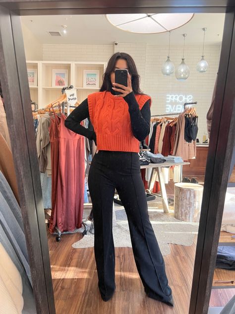 All black outfit with an orange vest for a pop of color. Sweater vest Crop Vest Sweater Outfit, Pumpkin Vest Outfit, Work Outfits Women Sweater Vest, Sweatervest Aesthetic Outfits Women, Orange Sweater Vest Outfit, Orange Vest Outfit, Orange Winter Outfit, Trendy Vest Outfit, Sweater Vest Outfit Summer