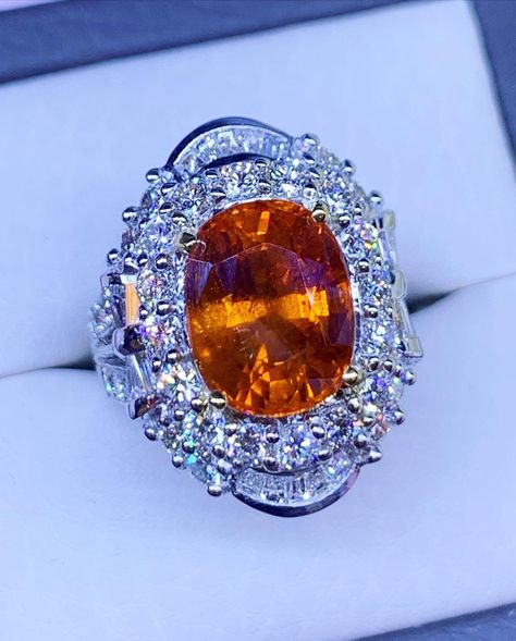 "ENJOY OUR WORRY-FREE SERVICE AND THE DAZZLING, GENUINE JEWELRY WE DESIGN AND HANDCRAFT WITH LOVE❤️ ABOUT THE ITEM: This ring is the perfect combination of elegance, beauty, and INVESTMENT VALUE! With a TRANSPARENT, SPARKLING, 11.35 carats, VIVID ORANGE SAPPHIRE, and 60 extremely sparkling diamonds. The ring was deliberately designed and handcrafted by our boutique's in-house goldsmiths. You will love this gorgeous piece as much we do. And people will absolute adore it once they see the sparkle and the vivacious color of this sapphire ring. EXTREMELY ELEGANT AND UQNIE, Certified 11.35 TCW Sapphire ring. ONE OF A KIND! CUSTOM-MADE RING, PERFECTLY HANDCRAFTED TO FIT THE ENCHANTING, VIVID, AND CLEAN SAPPHIRE SUGGESTED RETAIL VALUE: $12,500 SAPPHIRE: Weight: 8.05 carats Shape: OVAL CUT Color: Orange Sapphire Wedding Ring, Orange Diamond Ring, Orange Engagement Ring, Gold Band Engagement Rings, Real Diamond Necklace, Ceylon Sri Lanka, Sapphire Wedding, Vs Diamond, Orange Sapphire