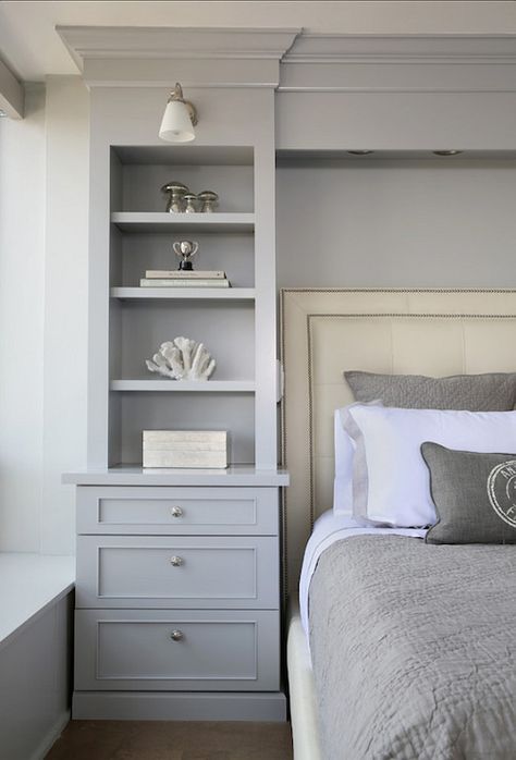 Gorgeous bedroom boasts gray built-in bookcase with lower drawers accented with round brushed nickel pulls lit by a frosted glass wall sconce beside an ivory leather bed with nail-head trim layered with gray bordered bed linens and a gray matelasse coverlet with matching shams. Cabinets Bedroom, Bedroom Built Ins, Transitional Bedroom, Remodel Bedroom, Closet Bedroom, Book Shelf, Beautiful Bedrooms, Bedroom Storage, Dream Bedroom