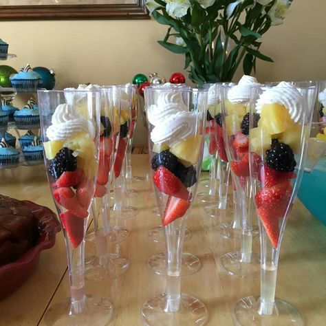 Champagne fruit cups. Use real or plastic champagne glasses and fill with three colorful fruits. I used strawberries, (sliced them to fit) blackberries, and pineapple. Topped with homemade whipped cream.  Perfect for a bridal or baby shower! Fruit Champagne Cups, Champagne Fruit Cups, Fruit In Cups For Party, Bridal Shower Fruit Cups, Champagne Glass Desserts, Fruit Cups For Wedding Reception, Party Fruit Cups, Fruit Cups Ideas, Fruit Cups For Party