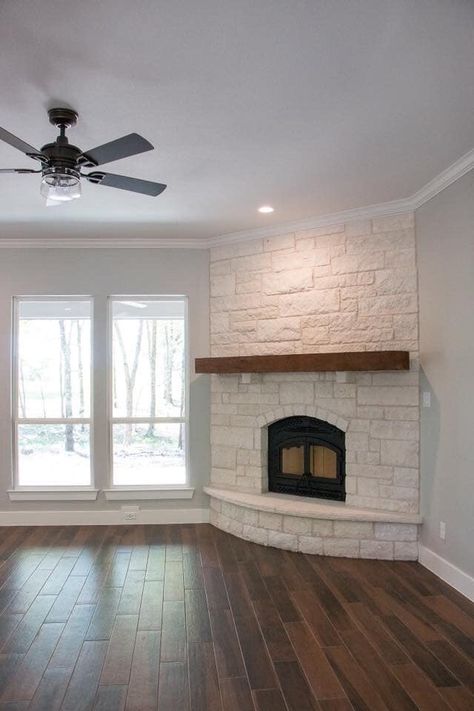 Rounded Brick Fireplace, White Stone Corner Fireplace, Rounded Hearth Fireplace, Corner Fireplace With Hearth And Mantle, Curved Corner Fireplace, Diagonal Fireplace, Fireplace With Doors On Each Side, Corner Fireplace Stone, Corner Brick Fireplace