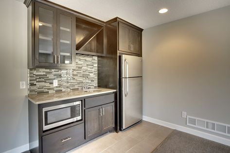 Wet Bar layout w/out peninsula 8' long upper and lower cabinets in knotty alder wood with stain Tile floor Tile backsplash Granite top in 2 color choices Sink in two choices Sink faucet Appliance package Bar With Full Size Fridge, Wet Bar Layout, Shed Apartment, Small Wet Bar, Wet Bar Cabinets, Bar Layout, Small Basement Kitchen, Kitchen With Peninsula, Basement Wet Bar