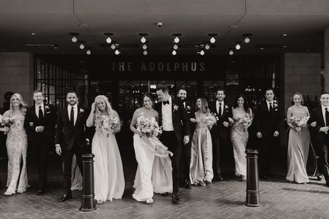 Black and white photo of the bride and groom, and bridal party walking in front of the Adolphus Hotel in Dallas, TX Bridal Party Hotel Pictures, The Adolphus Hotel, The Adolphus Dallas Wedding, City Wedding Party Photos, Adolphus Hotel Dallas Weddings, Hotel Wedding Photography, Bridal Party Wedding Photos, Party Wedding Photos, Hotel Pics