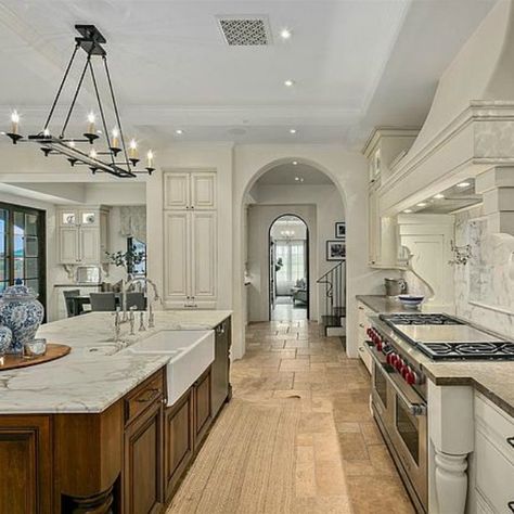 Elegant French country kitchen in luxurious Scottsdale home with stone floor, two tone cabinets, farm sink, and arch doorways. #luxuriouskitchen #frenchcountrykitchen #elegantdecor #kitchendesign Large French Country Kitchen, Beautiful Kitchens French Country, Luxury Country Kitchen, French Country Contemporary, French Country Countertops, Arch Doorways, Luxury Farmhouse Kitchen, Modern French Country Kitchen, French Seaside