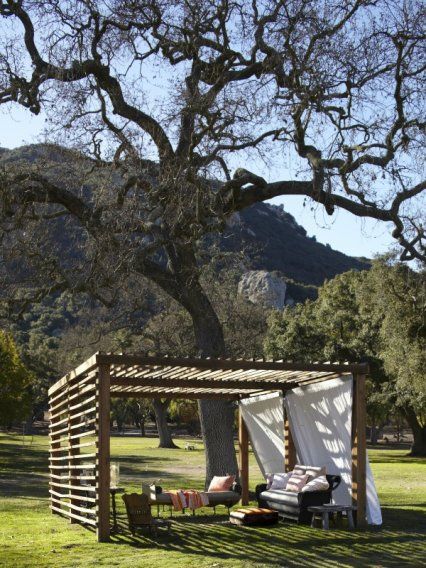 An oak tree shades the pergola with a French military day-bed and picturesque wicker sofa. Pergola Entrance, Relaxing Outdoor Spaces, Wooden Gazebo, Portia De Rossi, Garden Pavilion, Pergola Design, Desain Lanskap, Horse Ranch, Pergola Kits