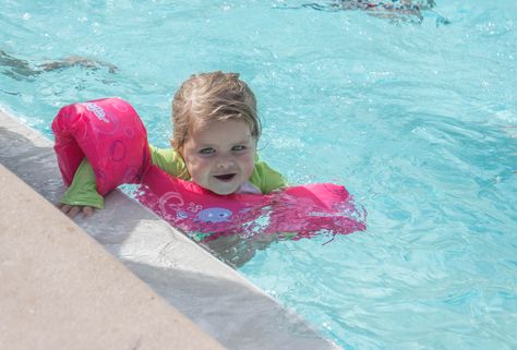 Keep kids safe by the pool or at the lake this summer by taking these 6 precautions. | FamilyEducation Swimming Pool Games, Safe Pool, Puddle Jumper, Ear Band, Deck Paint, Keeping Kids Safe, Pool Games, Games For Toddlers, Swim Lessons