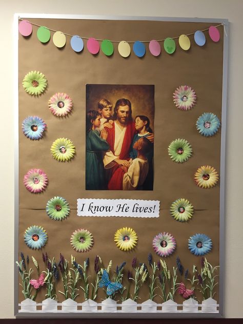 This Easter bulletin board was created with paint swatches and the center of the flowers had pictures from the kids in the congregation. Lds Nursery Decorations, Lds Nursery Easter Ideas, Lds Nursery Bulletin Board Ideas, Relief Society Ideas, Lds Easter, Easter Bulletin Board, Lds Decor, Lds Nursery, Library Door