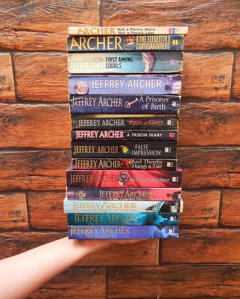 Holding a stack of Jeffrey Archer books on my hand in front of a brick wall. Jeffrey Archer Books, Paths Of Glory, Dan Brown Books, Sins Of The Father, Famous Five, Jeffrey Archer, Brown Books, Simple Acrylic, Enid Blyton