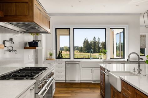 What Homeowners Want in Kitchen Islands Now Large Kitchen Window Over Sink, Black And White Farmhouse Kitchen, Modern Kitchen Window, Black White Kitchen, Kitchen Words, Steel Framing, Hardwood Floors Dark, White Counters, Farmhouse Kitchen Design