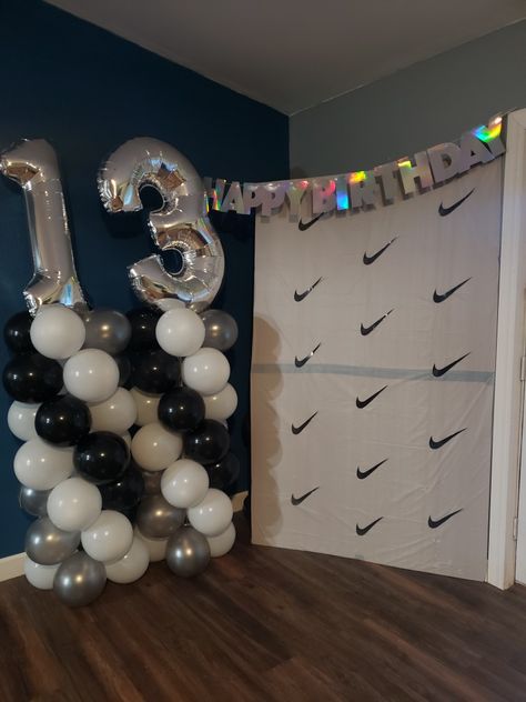 Black-and-white balloon towers Nike backdrop Nike Bday Party Ideas, Boy 13th Birthday Ideas, 14th Birthday Party Ideas For Boys, 13th Birthday Party Ideas For Boys, Dollar Tree Birthday, Golden Birthday Gifts, 13th Birthday Boys, 14th Birthday Party Ideas, Boy 16th Birthday