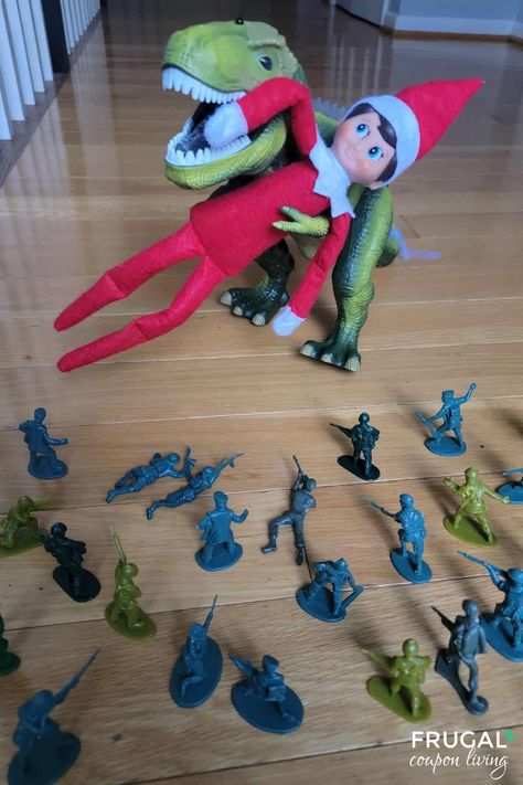 Looking for a creative and fun way to surprise your kids with your The Elf on the Shelf? This Dinosaur and Army Men Takeover idea is sure to bring excitement to your holiday season! Imagine your little Christmas elf caught in the jaws of a dinosaur, with brave toy soldiers rushing to the rescue. It’s a simple and playful setup that will have your kids giggling and your elf’s antics becoming the talk of the house! New Ideas for The Elf on the Shelf daily. Elf On The Shelf Dinosaur Ideas, Elf On The Shelf Dinosaur, Elf Printables, The Elf On The Shelf, Youth Group Games, Elf Fun, Elf Ideas, A Dinosaur, Army Men