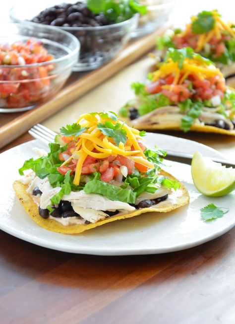 Rotisserie chicken is the shortcut to making a delicious tostada dinner in less than 30 minutes! Top store-bought tostadas (or you can make them yourself) with a spicy cream sauce, chicken, fiber-rich black beans and loads of other flavorful ingredients. Photo Credit: Julia Rutland Mole Tacos, Black Bean Tostadas, Bean Tostadas, Chicken Black Bean, Chicken Mole, Leftover Rotisserie Chicken, Rotisserie Chicken Recipes, Chicken Dinners, 500 Calories