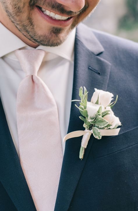 Grooms attire includes 2 piece black suit with light pink bush tie and mini white rose boutonniere with sating wrap.   #forthegroom #groomsattire #groomsmeninspiration #groominspiration  #pinkandblackgroomattire #groom #weddinginspirationforhim Light Pink Boutonniere, Black Groomsmen Suits, Wedding Musts, Pantone Rose, Pantone Rose Quartz, Black Groom, White Rose Boutonniere, Rose Quartz Wedding, Pink Boutonniere