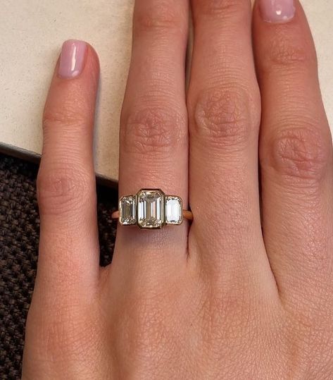 RACHEL BOSTON on Instagram: "A trilogy of striking rub-over set Emerald Cut diamonds form this sleek Deco-inspired ring. We love the proportions of these diamonds that create a stepped effect across the ring finger. ⠀⠀⠀⠀⠀⠀⠀⠀⠀ Tag a friend below who you think would like a Trilogy-style ring like this one 💫↓" Emerald Trilogy Engagement Ring, Rachel Boston, Emerald Cut Ring, Trilogy Engagement Ring, Emerald Cut Diamond, Emerald Cut Diamonds, Ring Finger, Tag A Friend, Emerald Cut