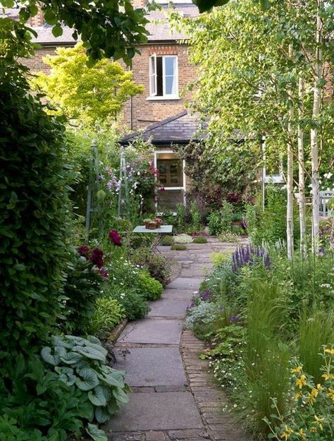 Picture of a cute narrow garden with a tile pathway, greenery and blooms is a dreamy space with a dining set Long Narrow Garden, Low Maintenance Garden Design, Narrow Garden, Courtyard Gardens Design, Courtyard Gardens, Back Garden Design, Garden Vines, Cottage Garden Design, Walled Garden